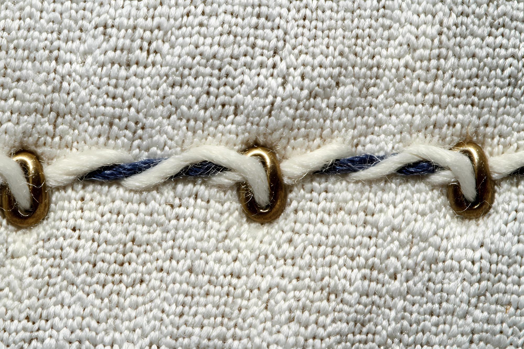 Close-up stitches in contrasting thread on wool